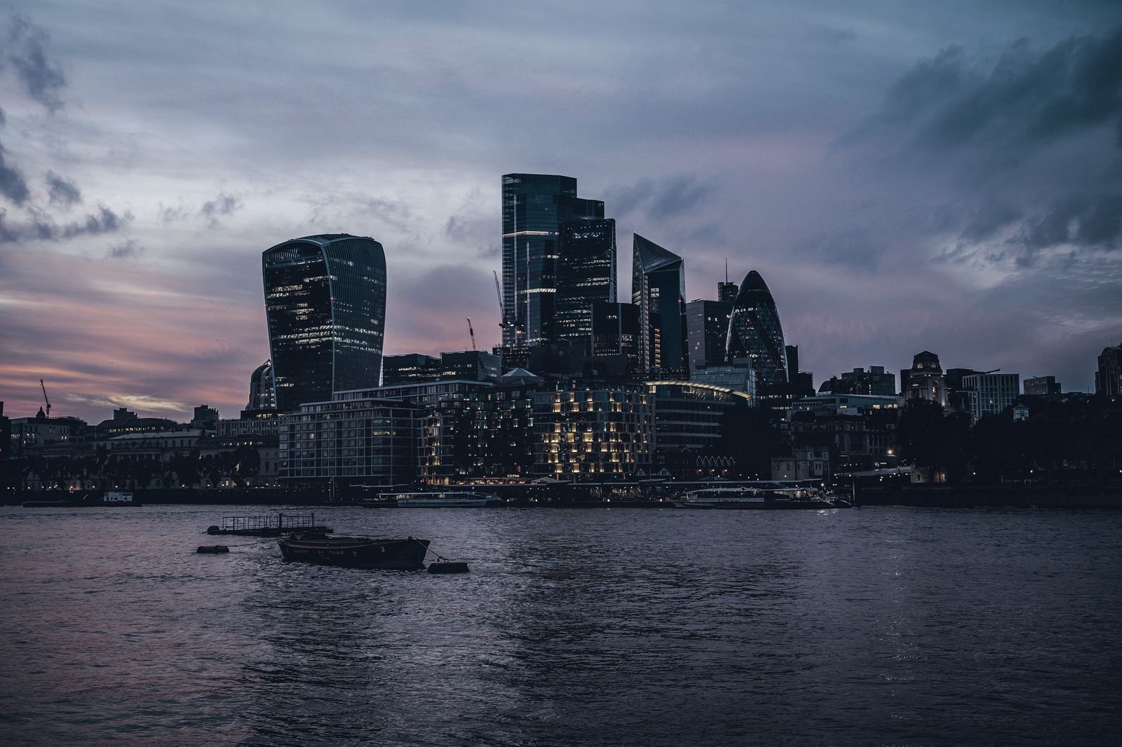 The City of London skyline at dusk, seen across the Thames